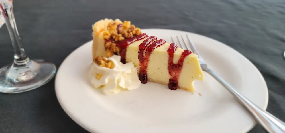 Cashew-Crusted Cheesecake with Raspberry Drizzle